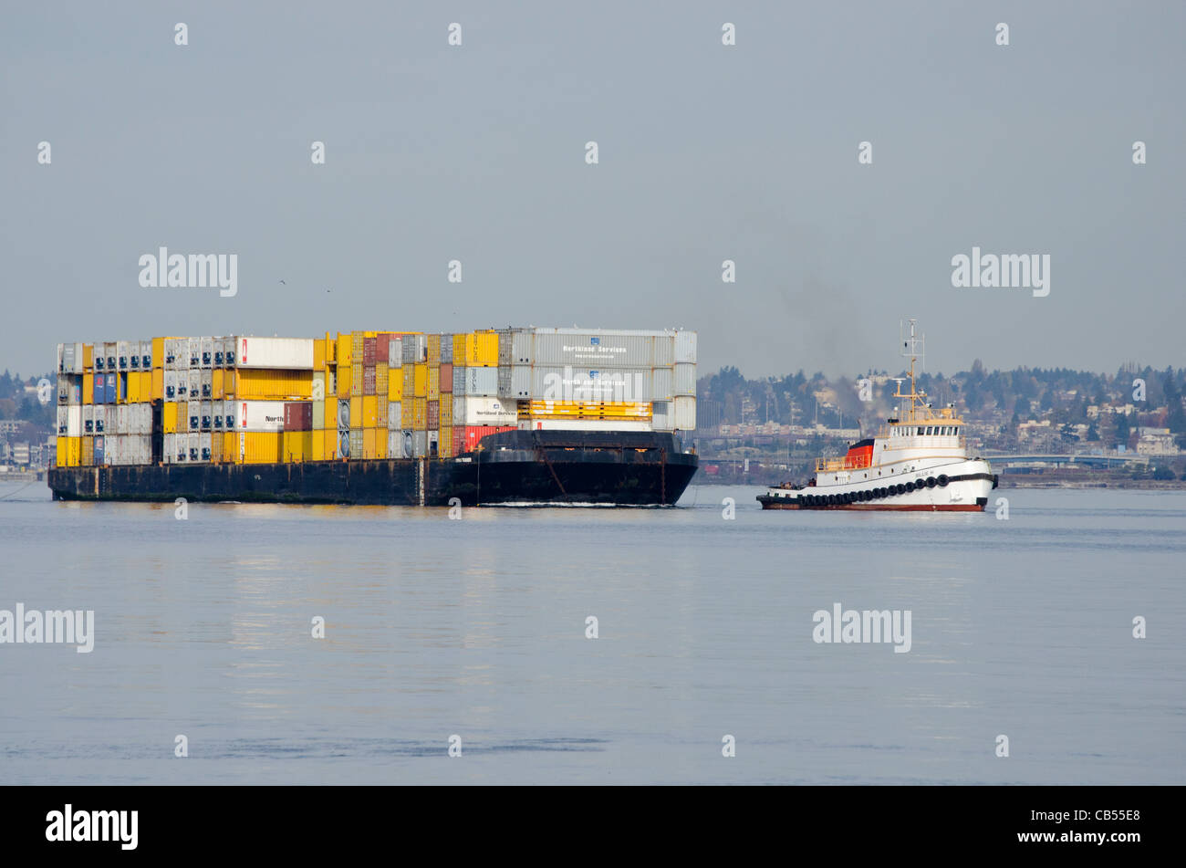 Tugboat pulling a shipping container barge in Puget Sound, Seattle, WA, USA Stock Photo