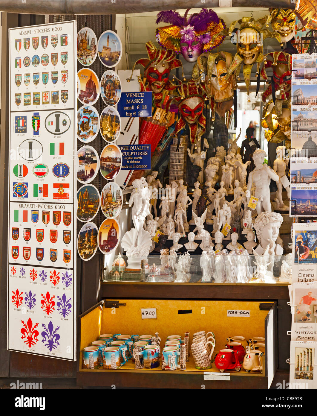 Souvenirs in a Florence street stall. mugs, statuettes, masks, stickers, fleur de lis, David, Venus, Leaning tower of Pisa Italy Stock Photo