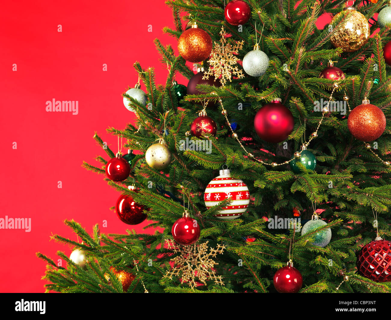 Closeup of Christmas tree colorful decoration on bright red background Stock Photo