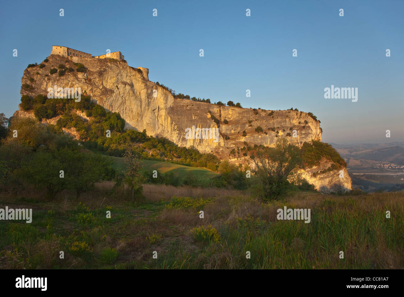 The Fortress, a castle on rocky crag, at sunrise at village of San Leo, Emilia-Romagna, Italy, AGPix 1992 Stock Photo