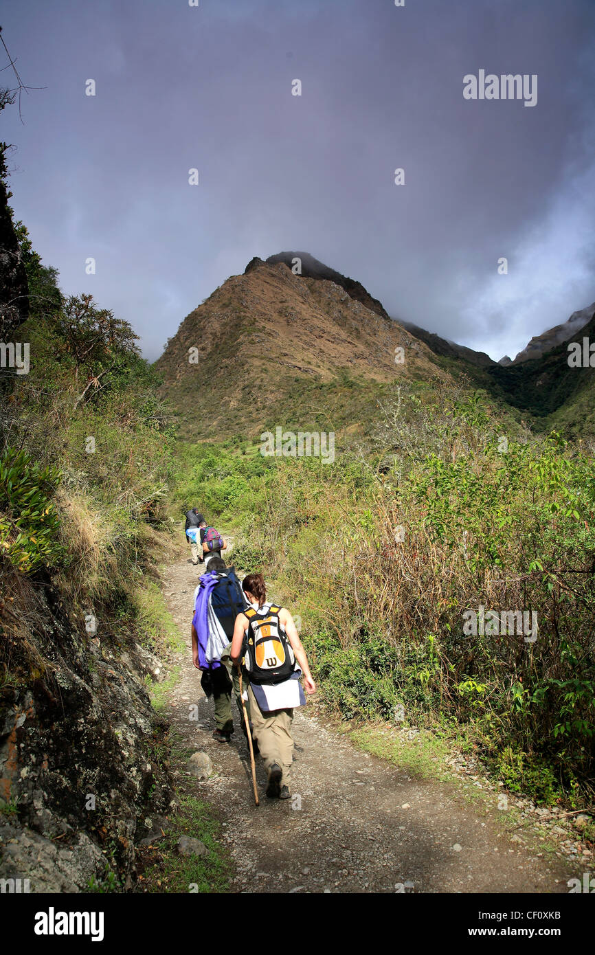 Adult tourists trekking up to Dead Woman Pass, Inca Trail, Cusco region, Peru, South America Stock Photo