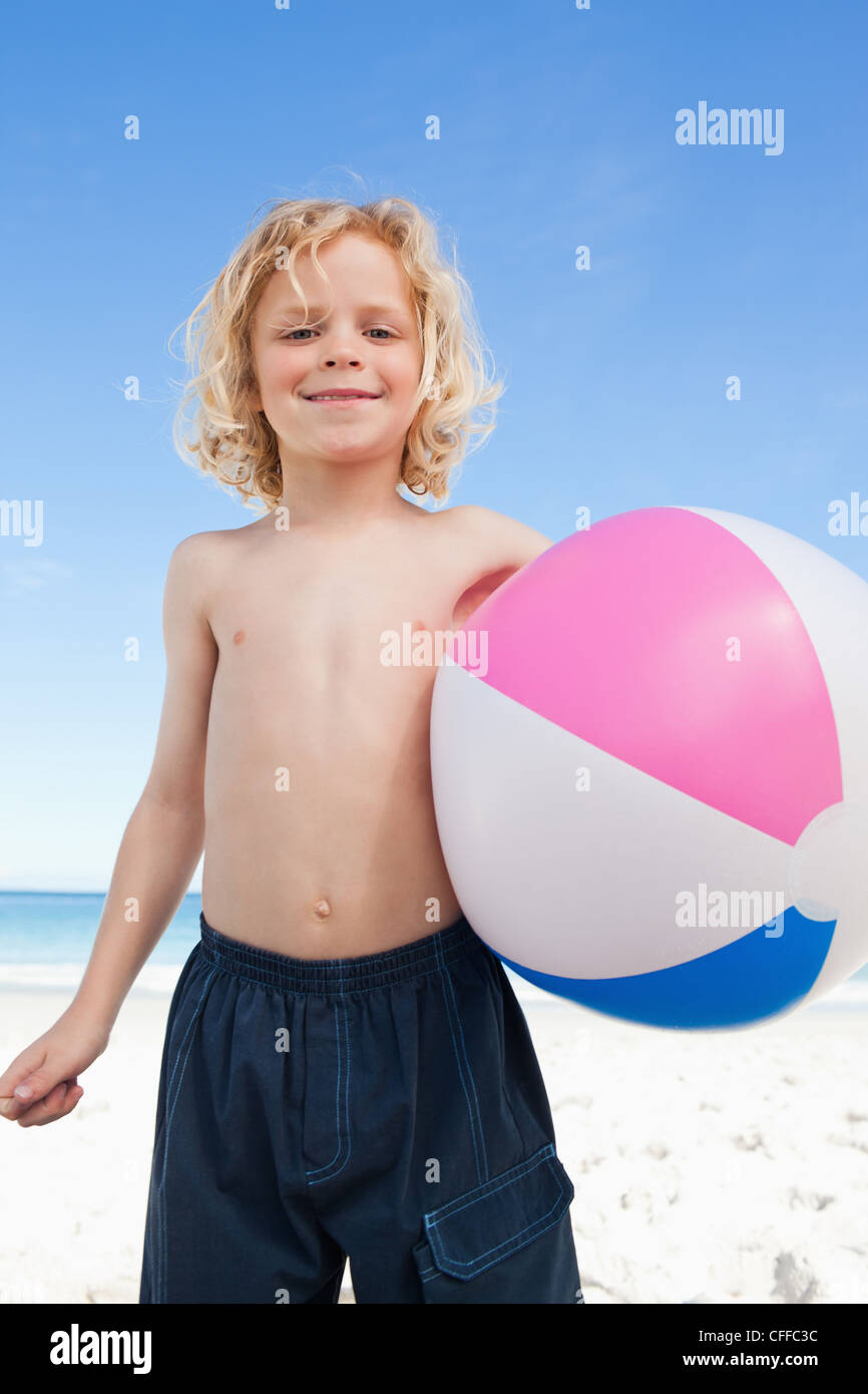 Boy on the beach with beach ball Stock Photo