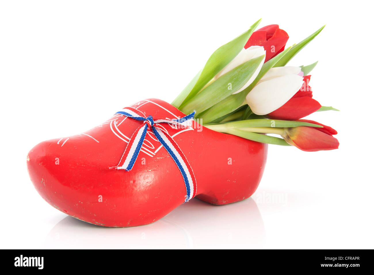 Red Dutch wooden clogs with colorful tulips Stock Photo