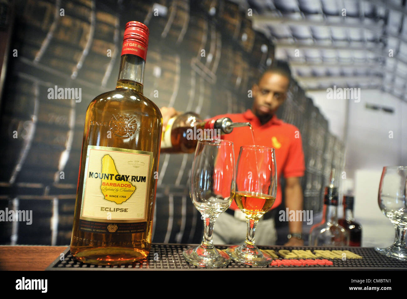 June 12, 2012 - Bridgetown, Barbados, U.S. - An employee pours a tasting inside a replica of a traditional rum shop at the Mount Gay Rum Distillery in Bridgetown, Barbados. Mount Gay Rum is the oldest existing brand of rum in the world. (Credit Image: © Josh Edelson/ZUMAPRESS.com) Stock Photo