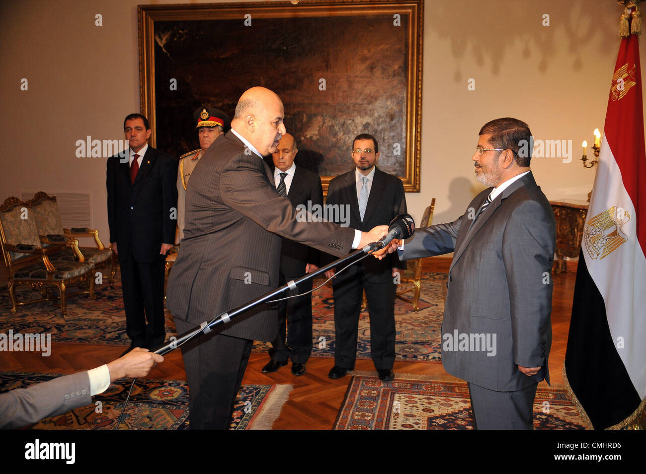 Aug. 11, 2012 - Cairo, Cairo, Egypt - President Mohammed Morsi (R) shaking hands with his newly appointed vice president, former judge Mahmud Mekki during a swearing-in ceremony at the presidential palace in Cairo on August 12, 2012. Egypt's Islamist president also ordered the surprise retirement of his powerful defence minister and scrapped a constitutional document which handed sweeping powers to the military  (Credit Image: © Egyptian Presidency/APA Images/ZUMAPRESS.com) Stock Photo