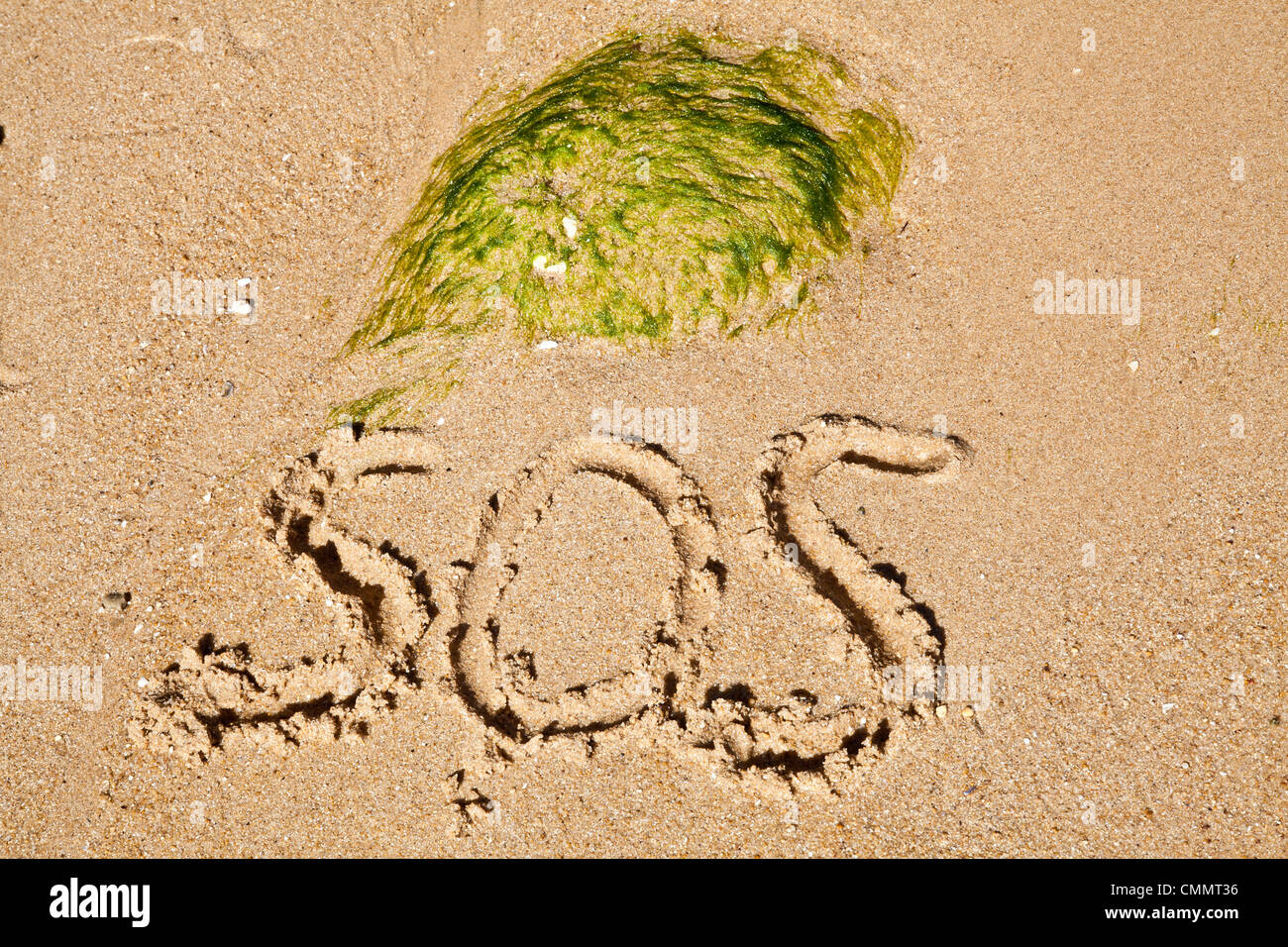 SOS on sandy beach Stock Photo