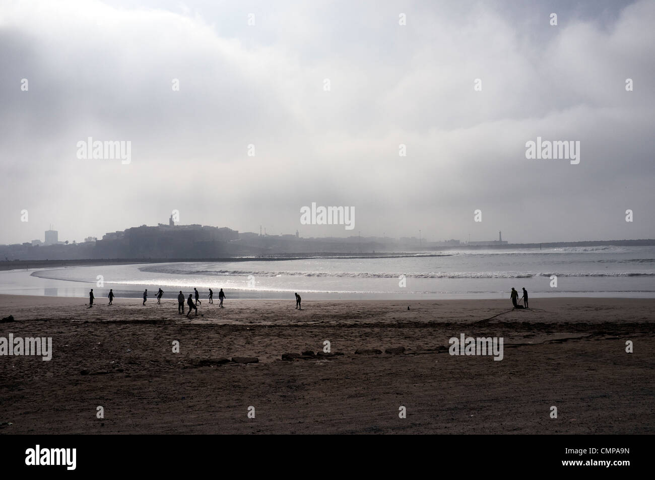 Football taking place on the beach Salé with Rabat in the background, north west Morocco Stock Photo