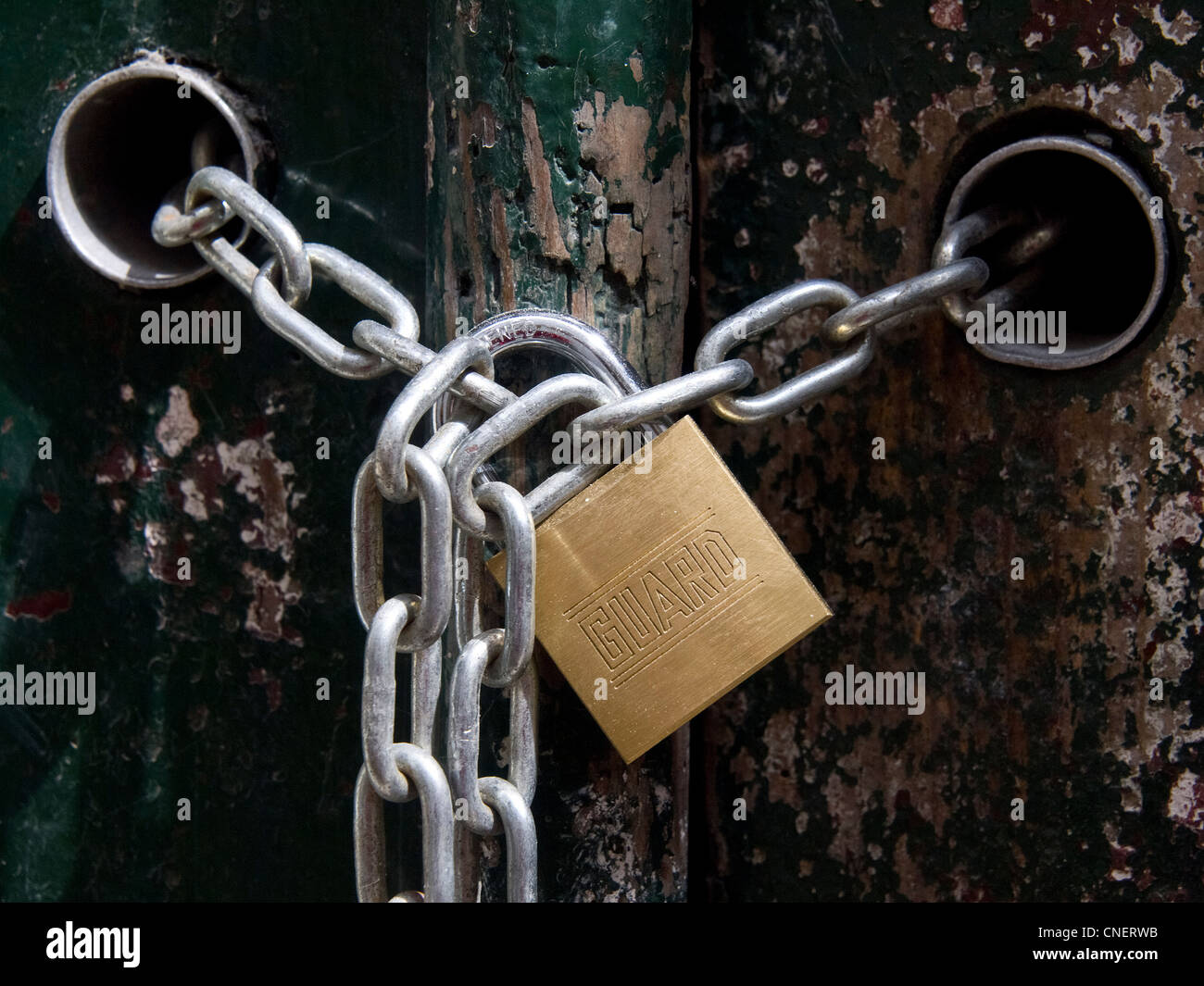 Padlock and chains on door house Stock Photo