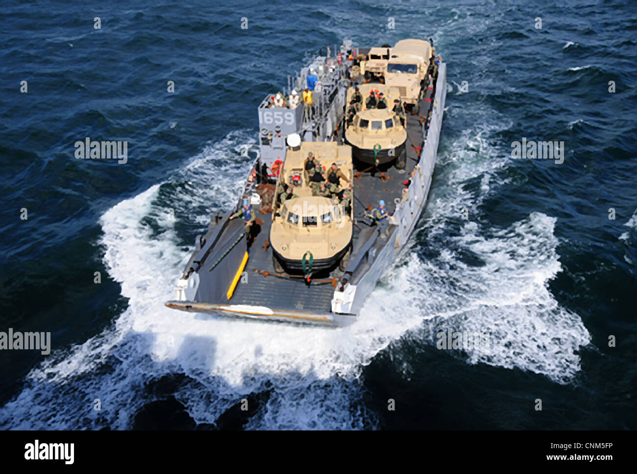 A US Navy Landing Craft approaches the well deck of the amphibious assault ship USS Wasp April 10, 2012 in the Atlantic Ocean. Stock Photo