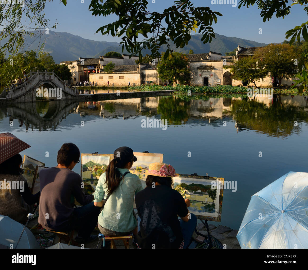 Group of student painters at South Lake in Hongcun World Heritage Site Anhui Province China Stock Photo