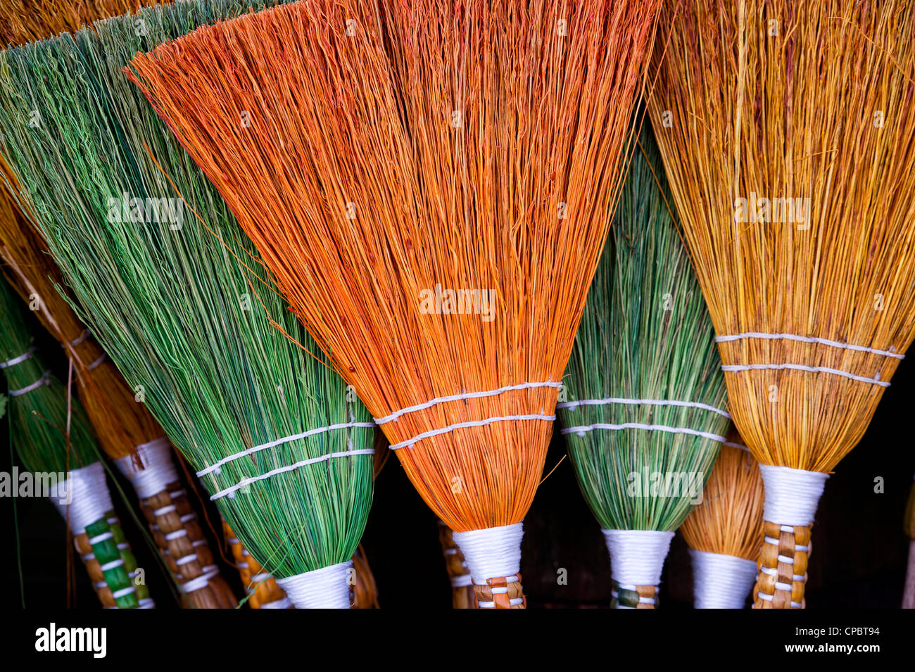 Coloured handmade brooms Stock Photo