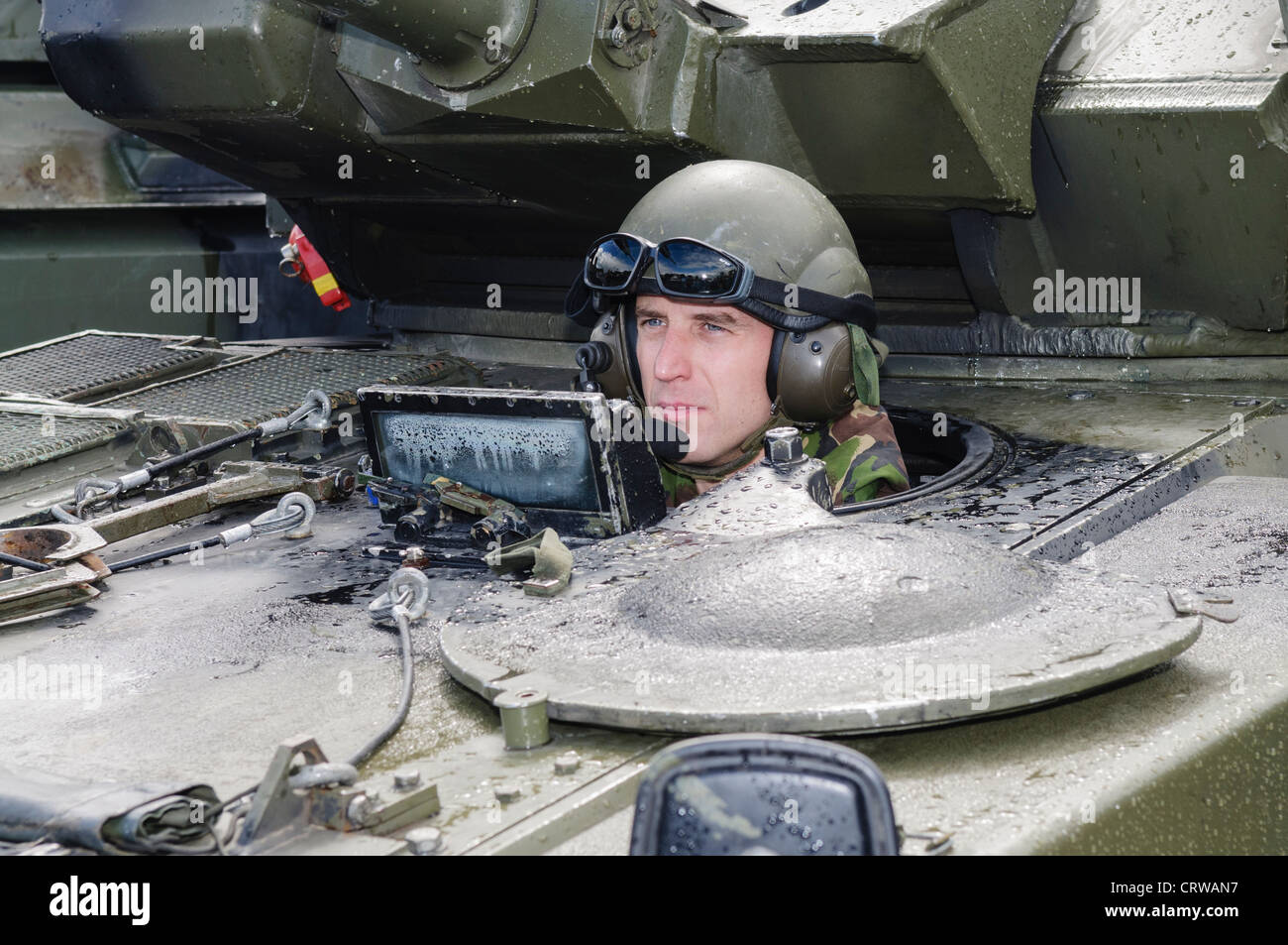 Soldier drives a Scimitar reconnaisance vehicle Stock Photo