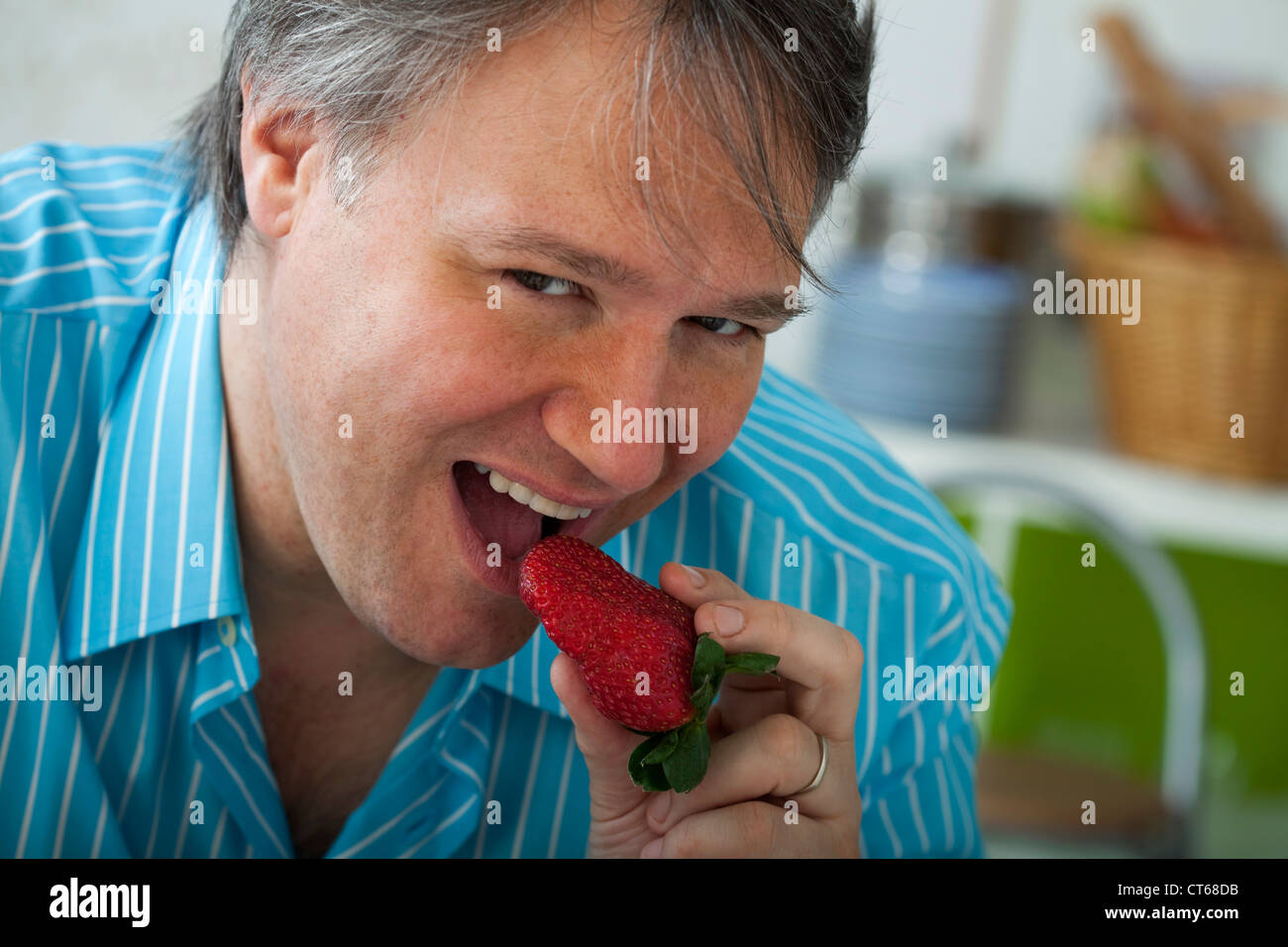 MAN EATING FRUIT Stock Photo