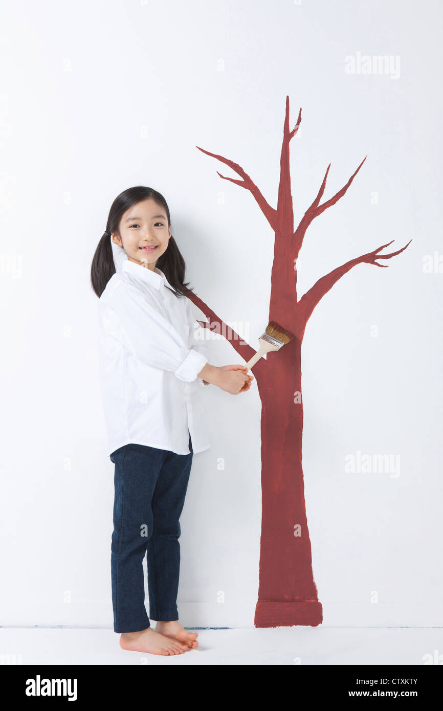 A girl painting the tree Stock Photo