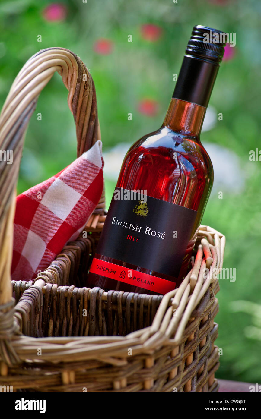 English Rose wine bottle with screwcap and wicker basket in garden picnic situation Tenterden England UK Stock Photo