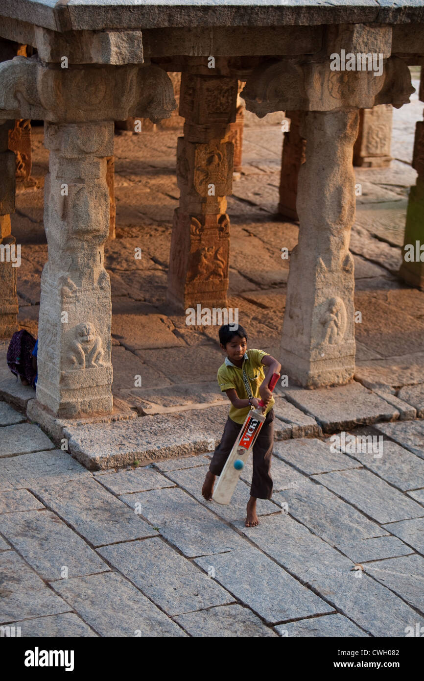 Indian boys playing cricket in Hampi Bazaar Stock Photo