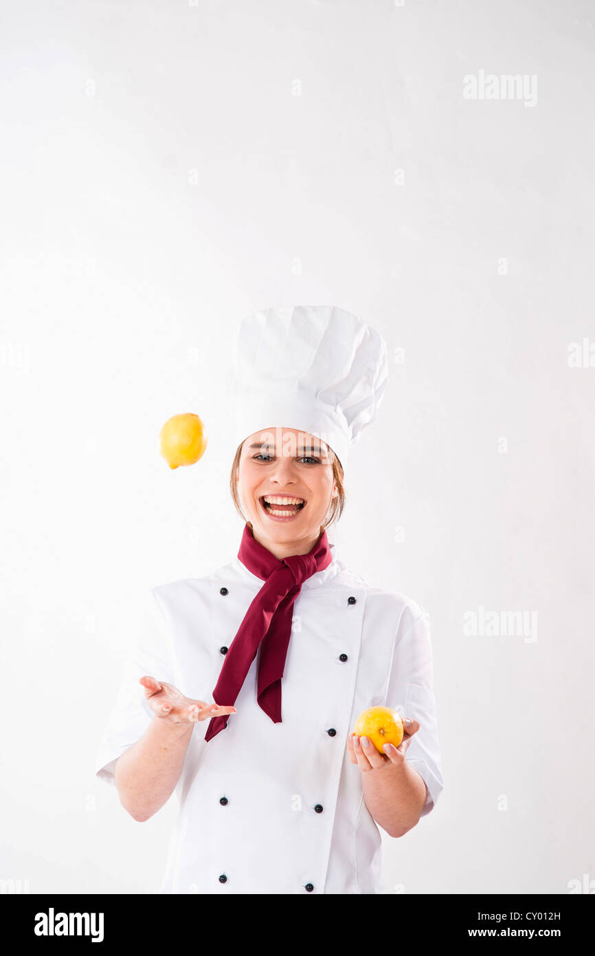 Young chef juggling lemons Stock Photo