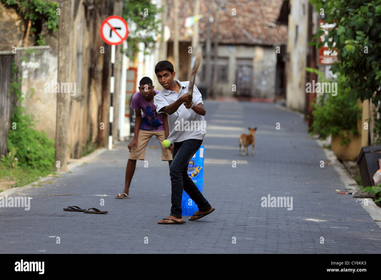 Sri Lankan boys playing cricket in the street inside Galle Fort. Stock Photo