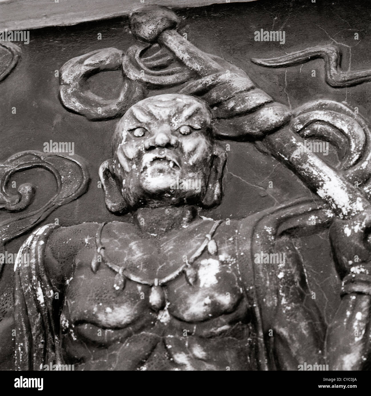 Travel Photography - Sinister carving art in Hoi An in Vietnam in Southeast Asia Far East. Religion Religious Stock Photo