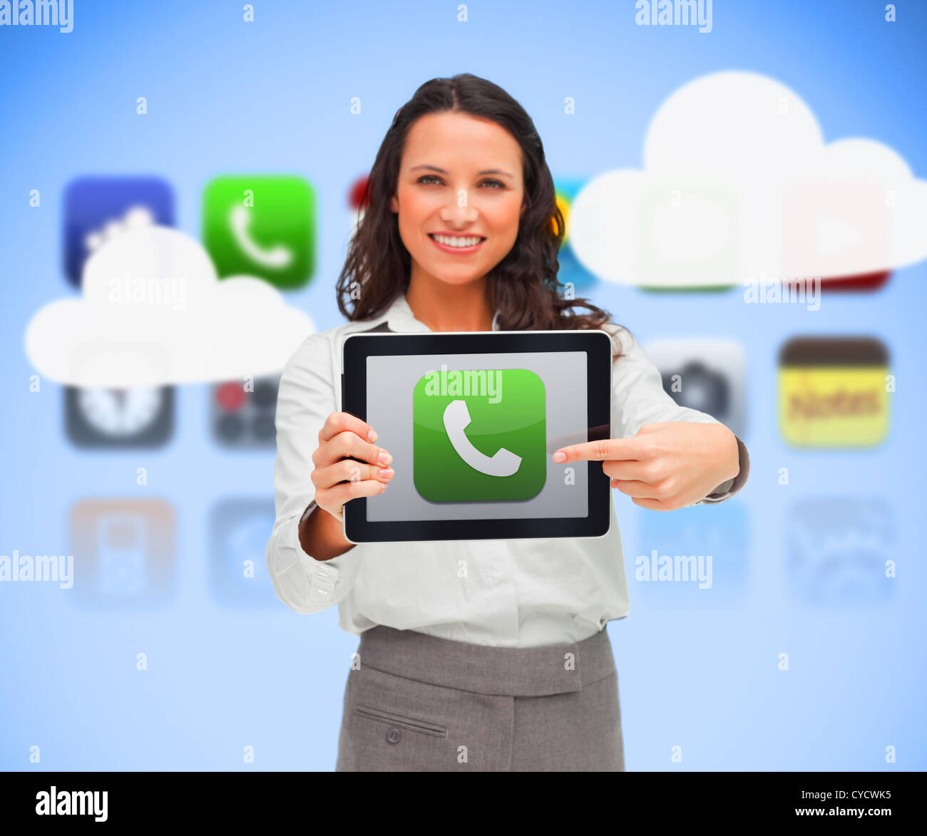 Businesswoman holding a tablet computer while smiling with phone symbol on screen Stock Photo