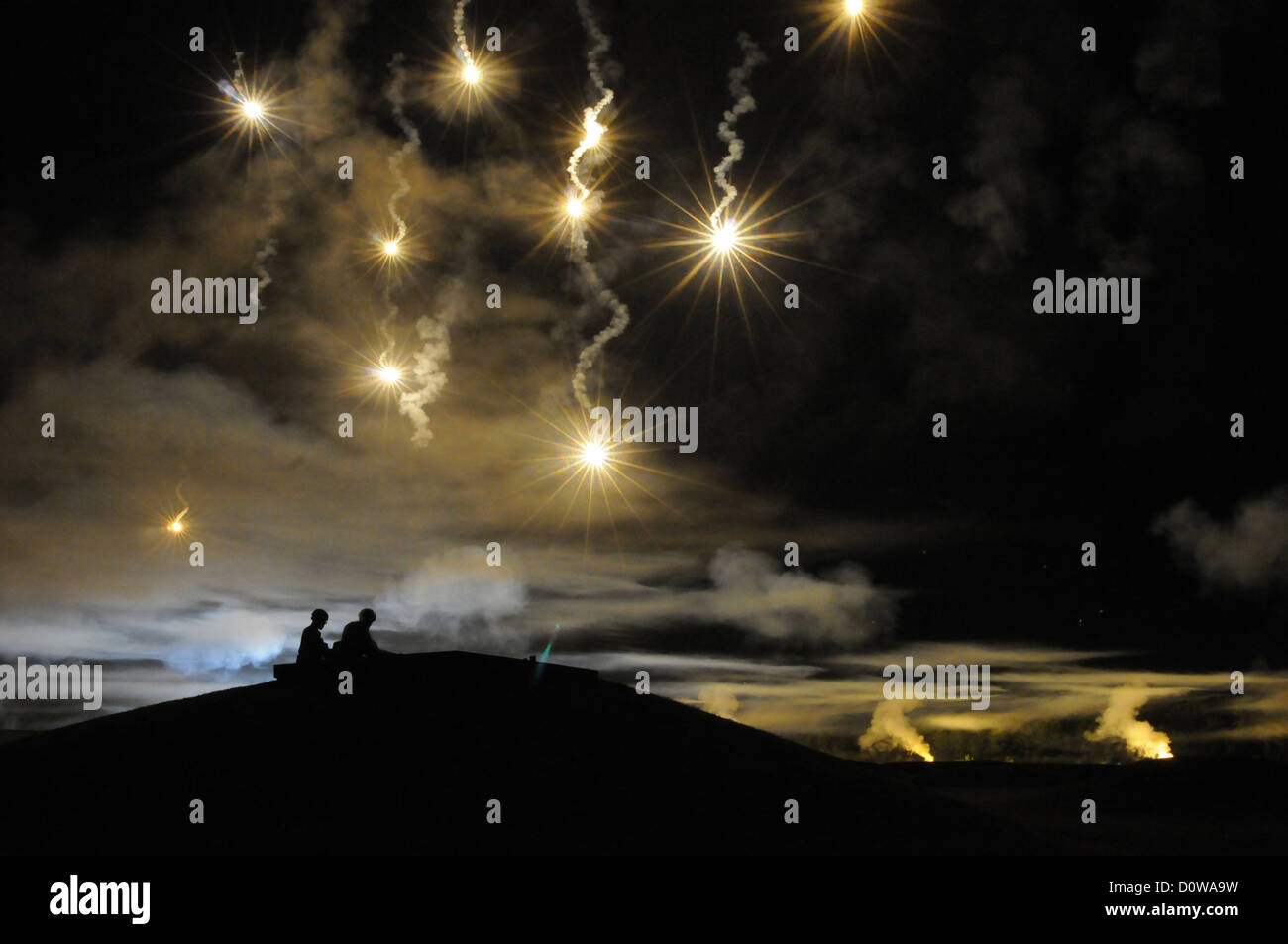 US Army soldiers watch flares light up the night sky during training October 1, 2012 at Fort Lee, Virginia. Stock Photo