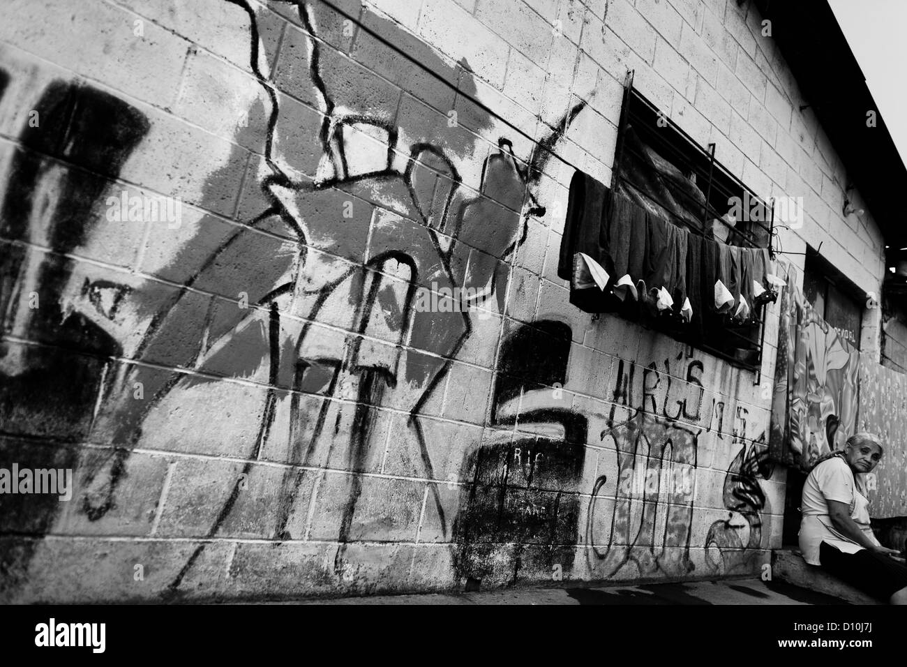 A gang graffiti (“Devil's horns”) painted on the wall in the Mara Salvatrucha gang neighborhood in San Salvador, El Salvador. Stock Photo