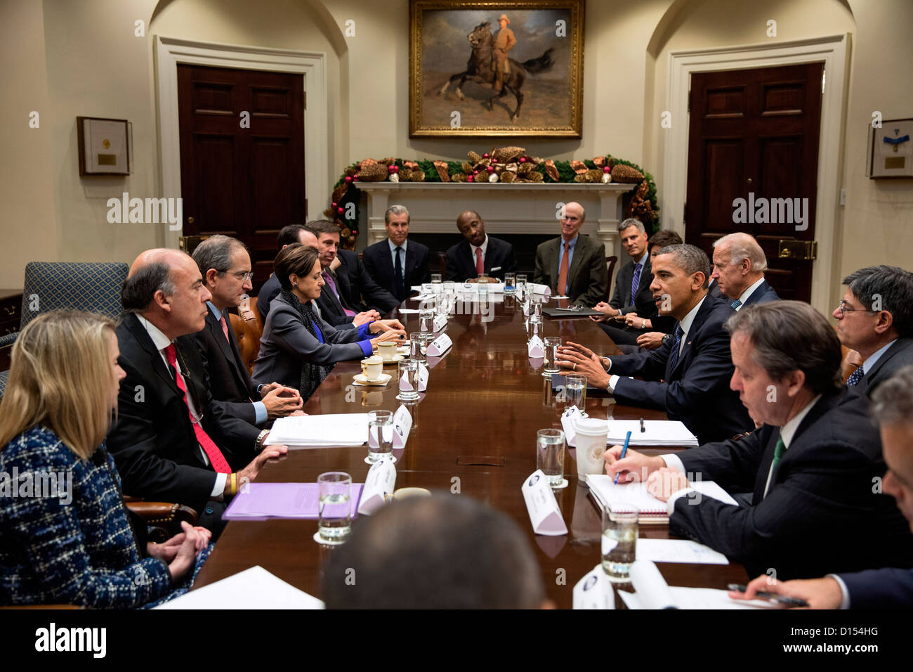 US President Barack Obama and Vice President Joe Biden meet with business leaders to discuss the actions needed to keep the economy growing and find a balanced approach to reduce the deficit in the Roosevelt Room of the White House November 28, 2012 in Washington, DC. Stock Photo