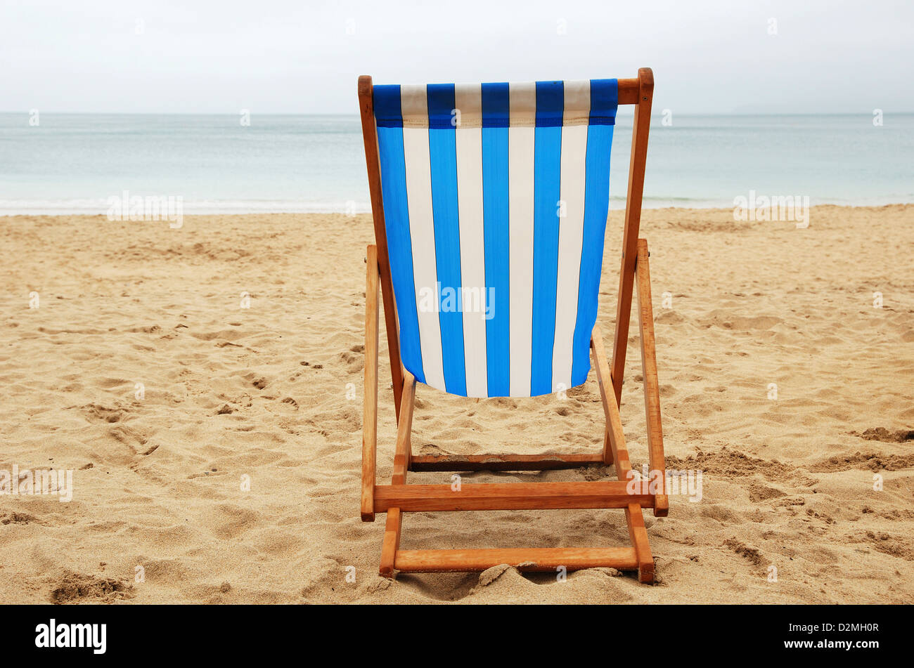 A deck chair on an empty beach Stock Photo