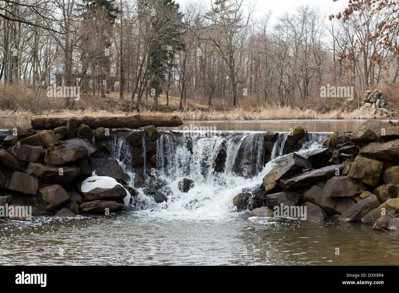 A rocky man made waterfall cascade with upper and lower lake. Stock Photo