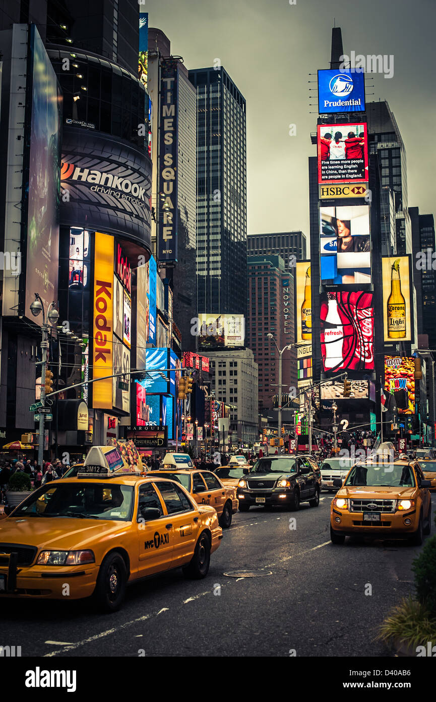 Taxi cabs in New York's Times Square at night Stock Photo