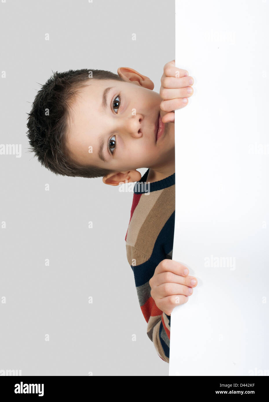 Little boy holding a whiteboard. White isolated studio shot Stock Photo