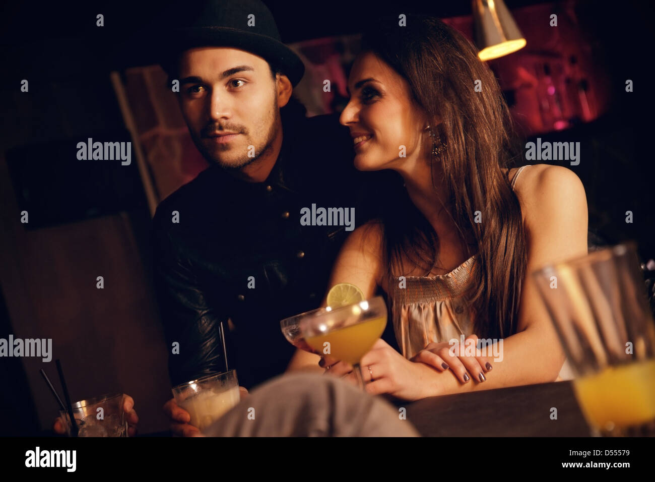 Young couple enjoying their date at the bar with their friends Stock Photo