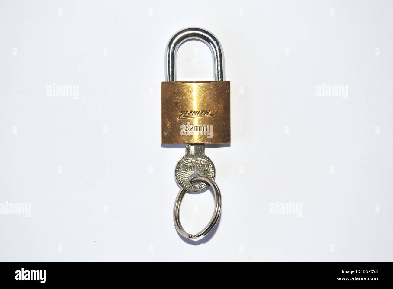 A locked Zenith padlock and key photographed in a studio. Stock Photo