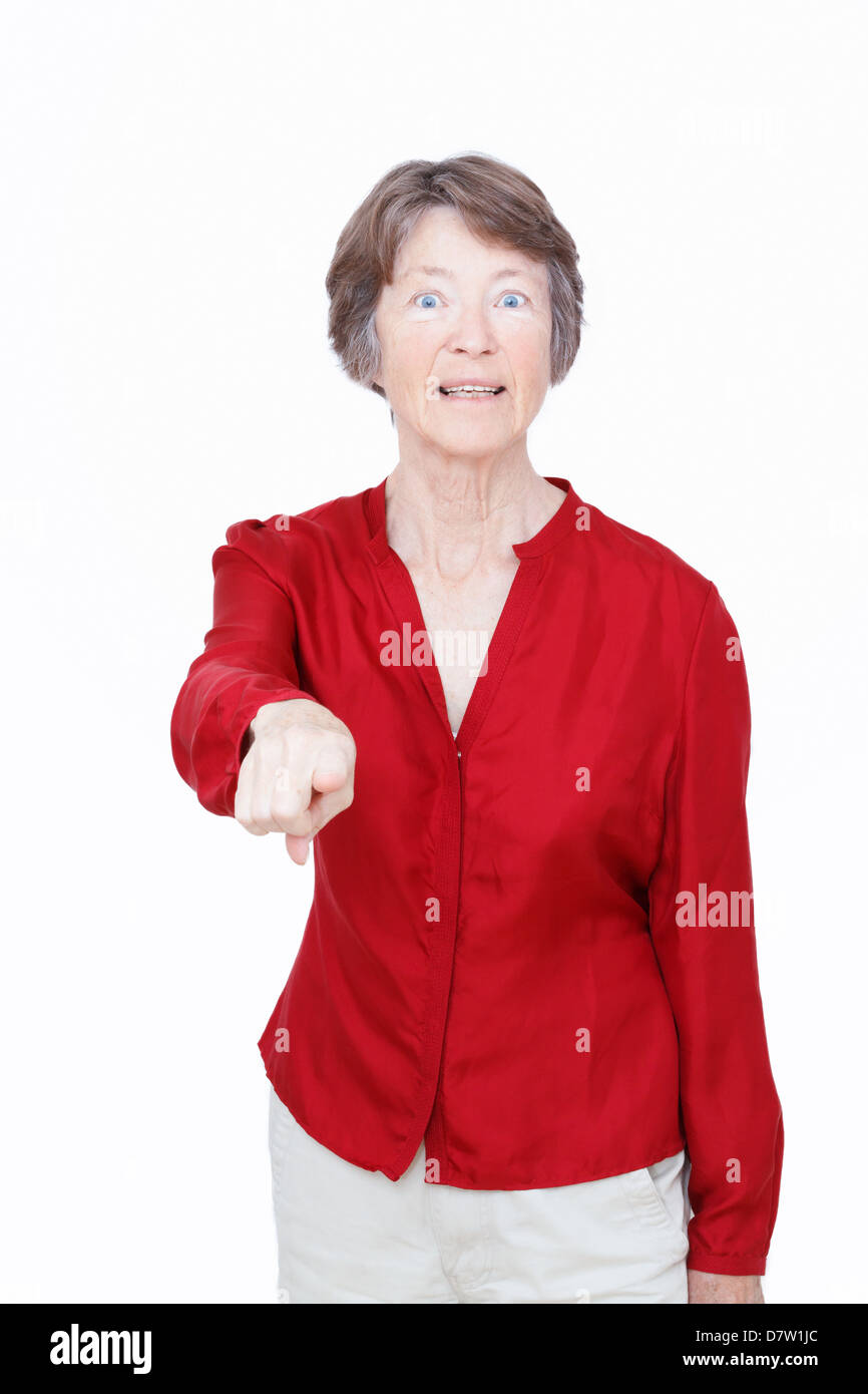 Studio portrait of senior woman pointing. Stock Photo