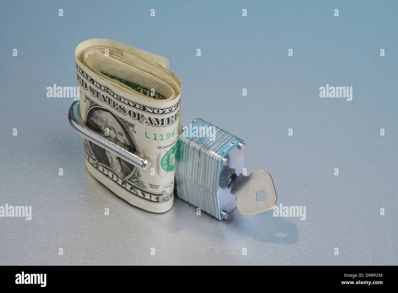 Dollar bills in an open padlock Stock Photo