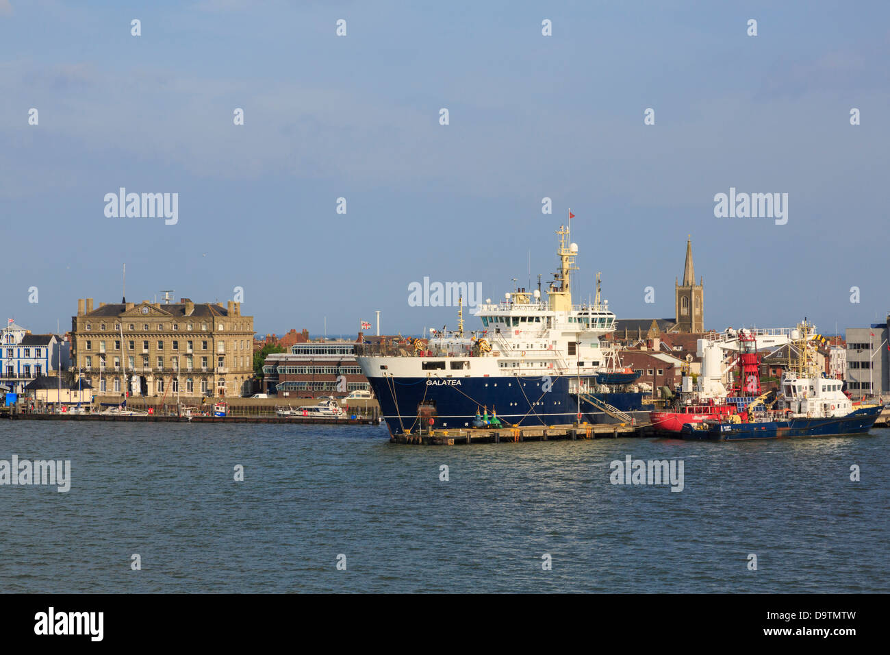 Offshore view across sea to Trinity House THV Galatea tender vessel docked in harbour of Harwich, Essex, England, UK, Britain Stock Photo