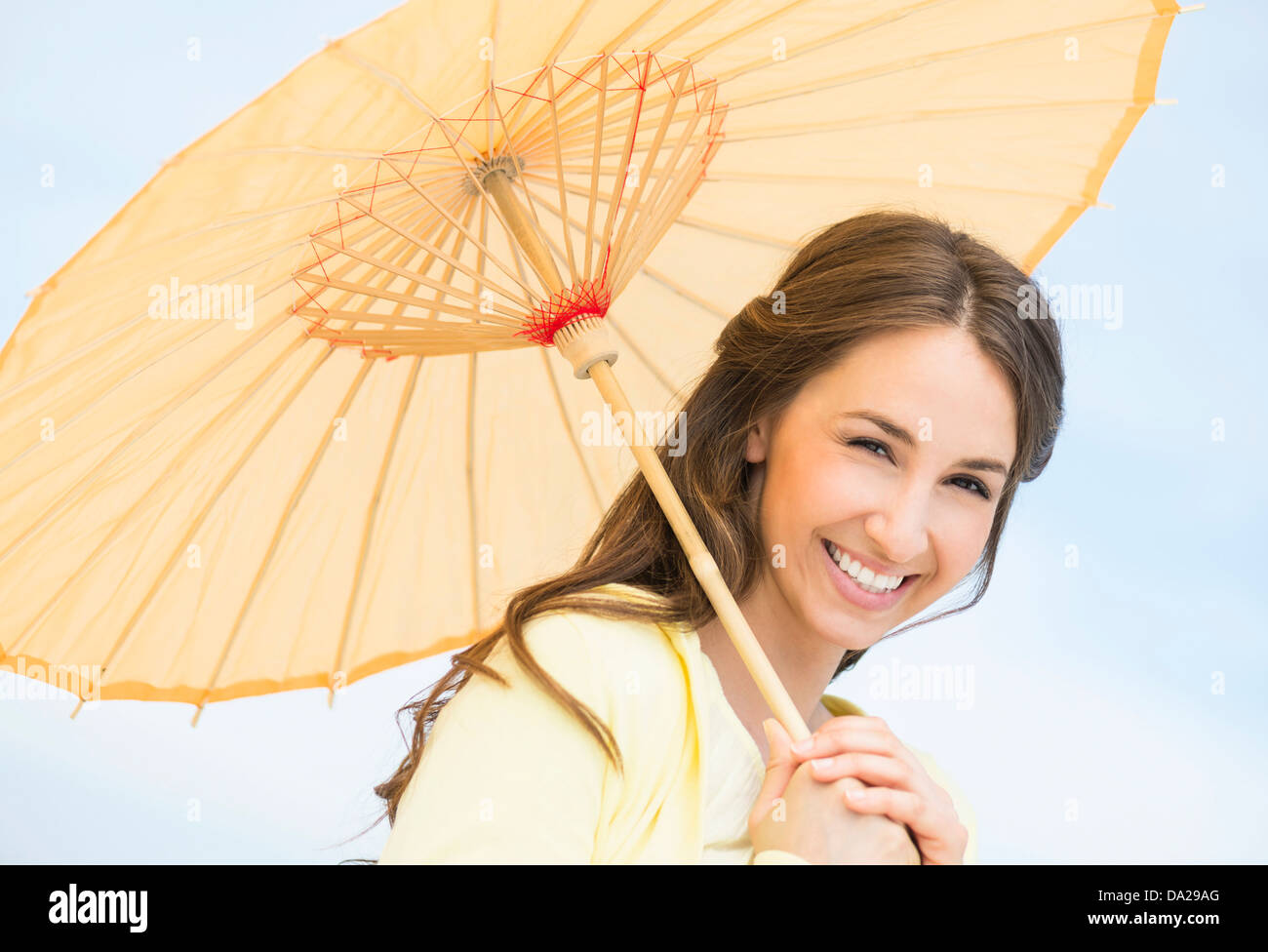 Portrait of beautiful young woman with parasol Stock Photo