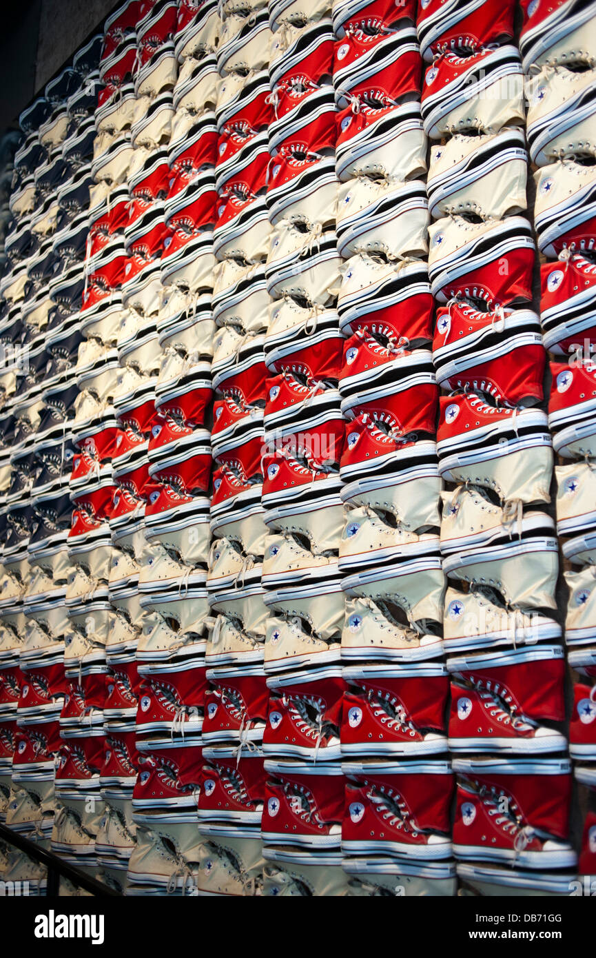 Converse Chuck Taylor All Stars tennis shoes on the wall at the Converse Shoe store in New York City Stock Photo