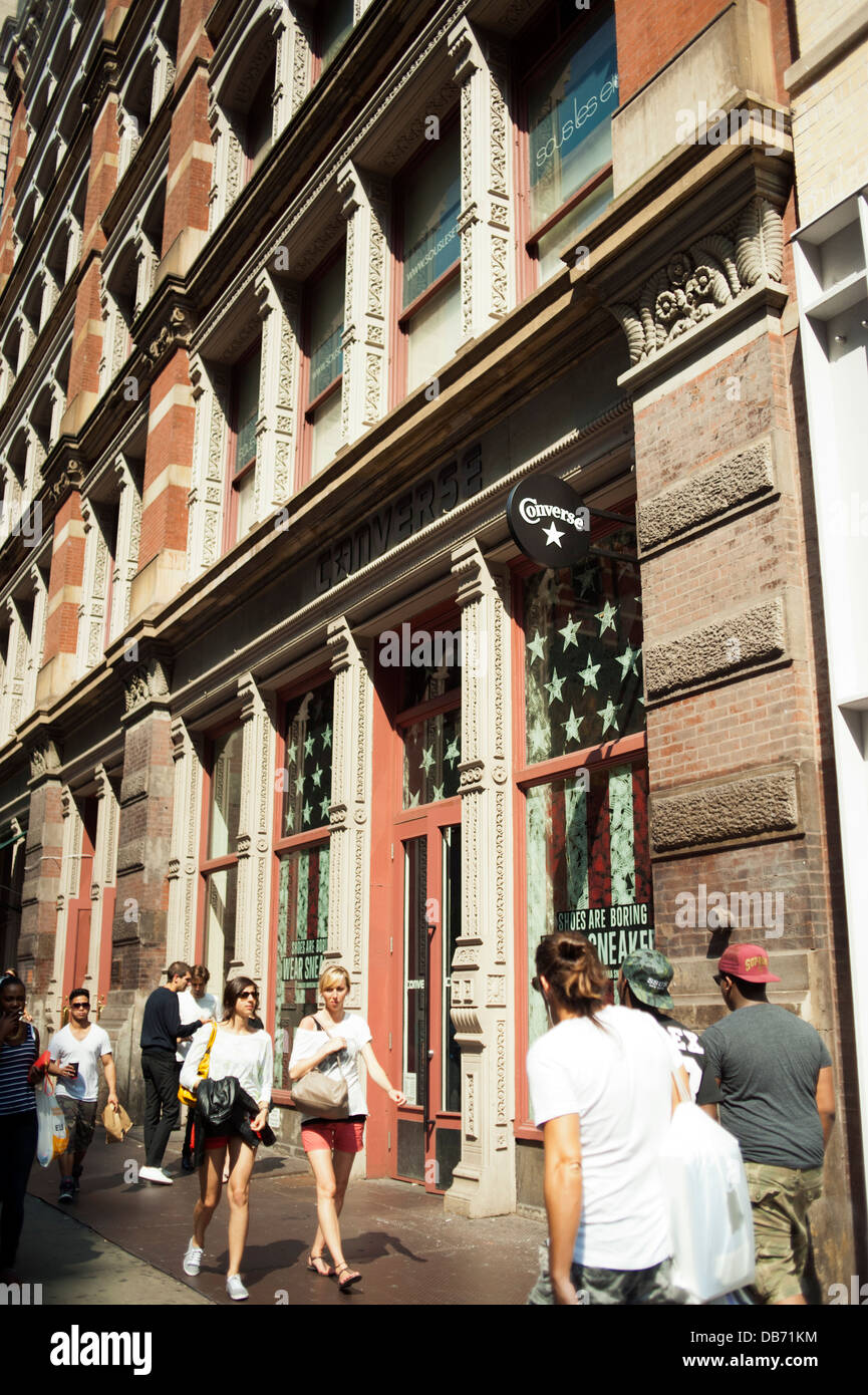 People walking in front of the Converse Shoe store in New York City Stock Photo