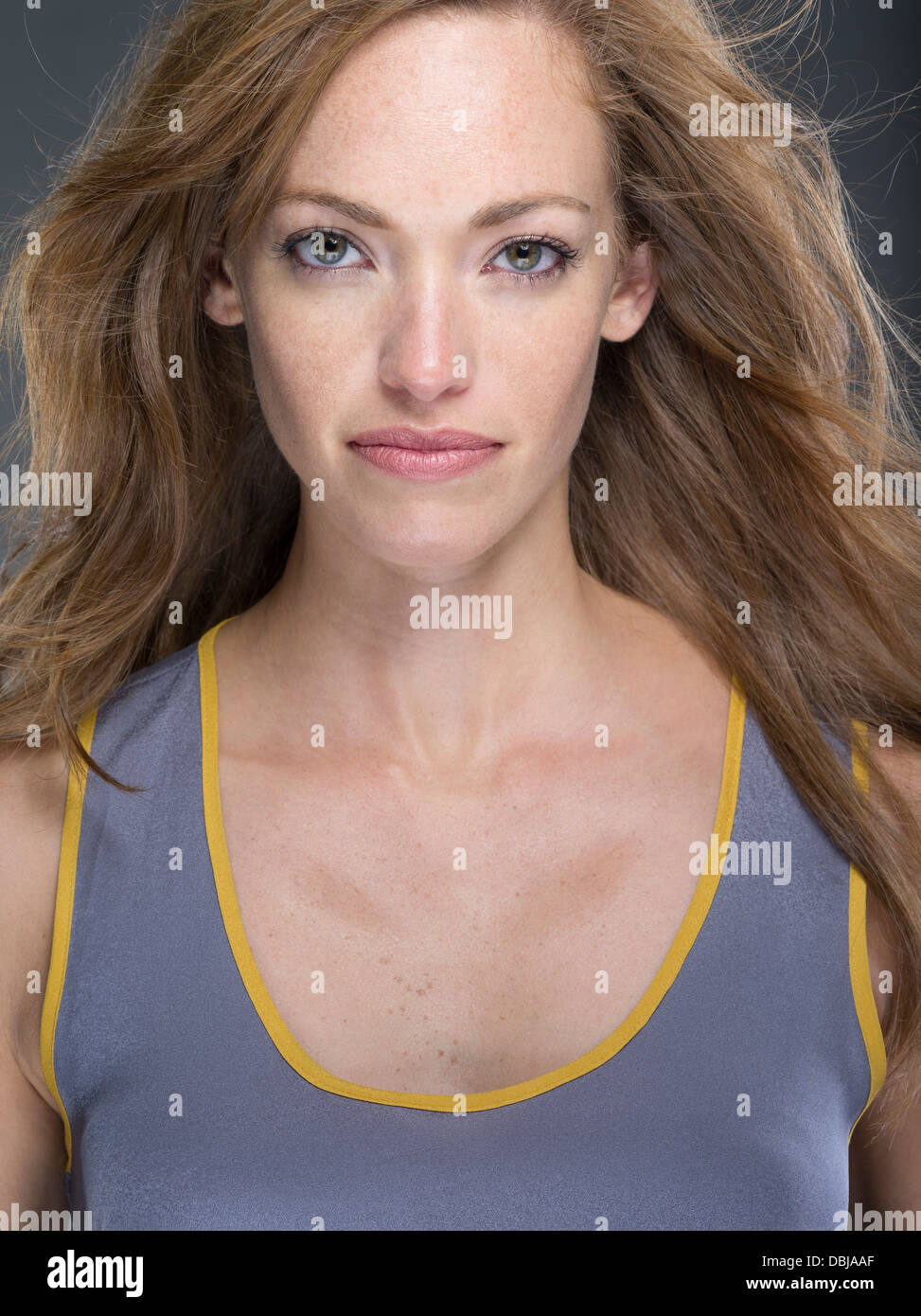 Young Caucasian woman with strawberry blond hair wearing sportswear shirt looking at camera Stock Photo