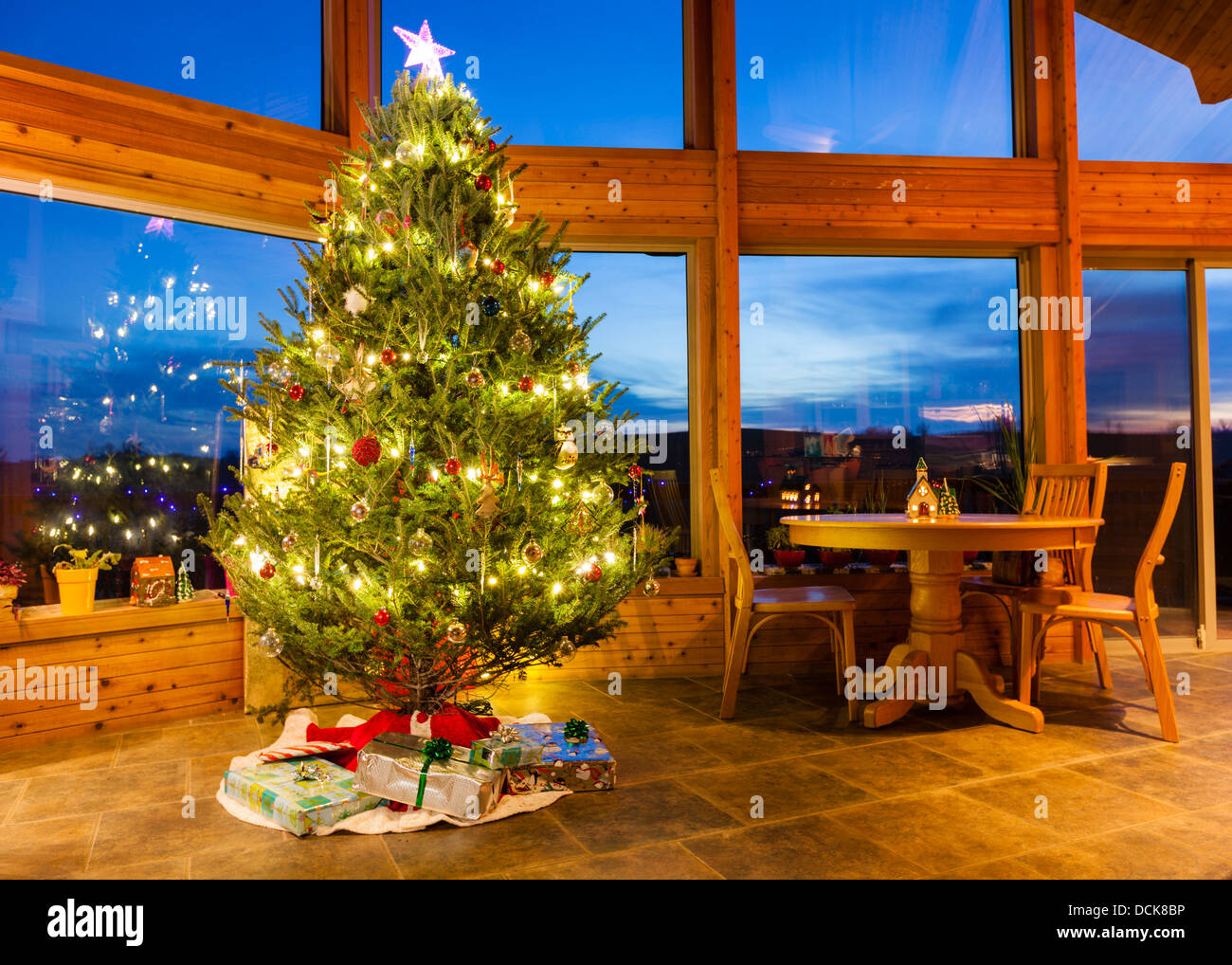 Christmas tree in a modern home with large windows Stock Photo