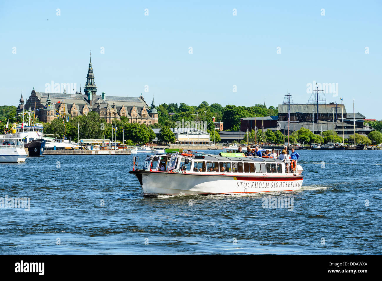 Sightseeing boat at Nybroviken Stockholm Sweden with Djurgården museums behind including Junibacken, Vasamuseet, Nordiska museet Stock Photo