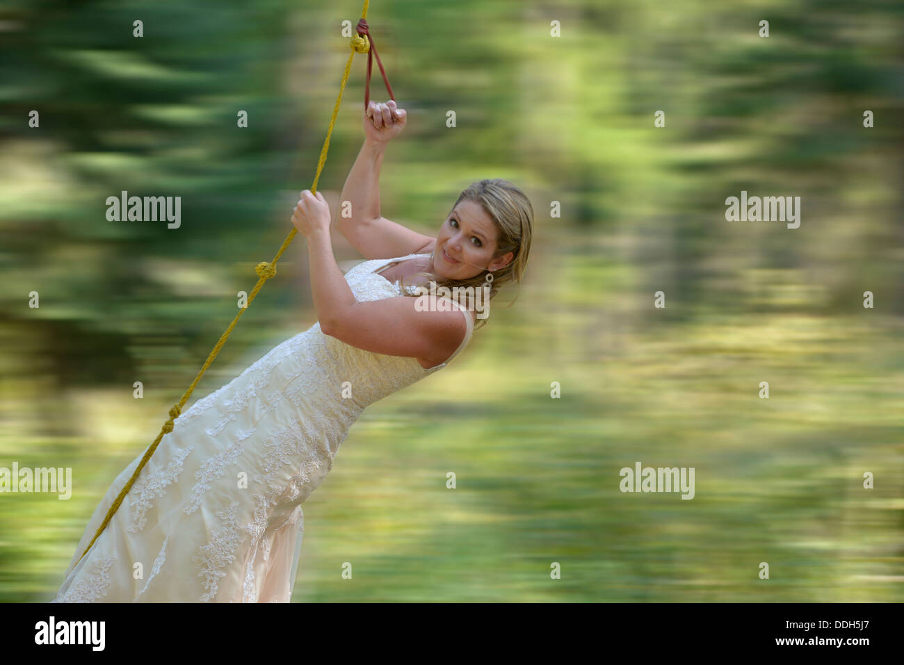 Bride on a rope swing. Stock Photo