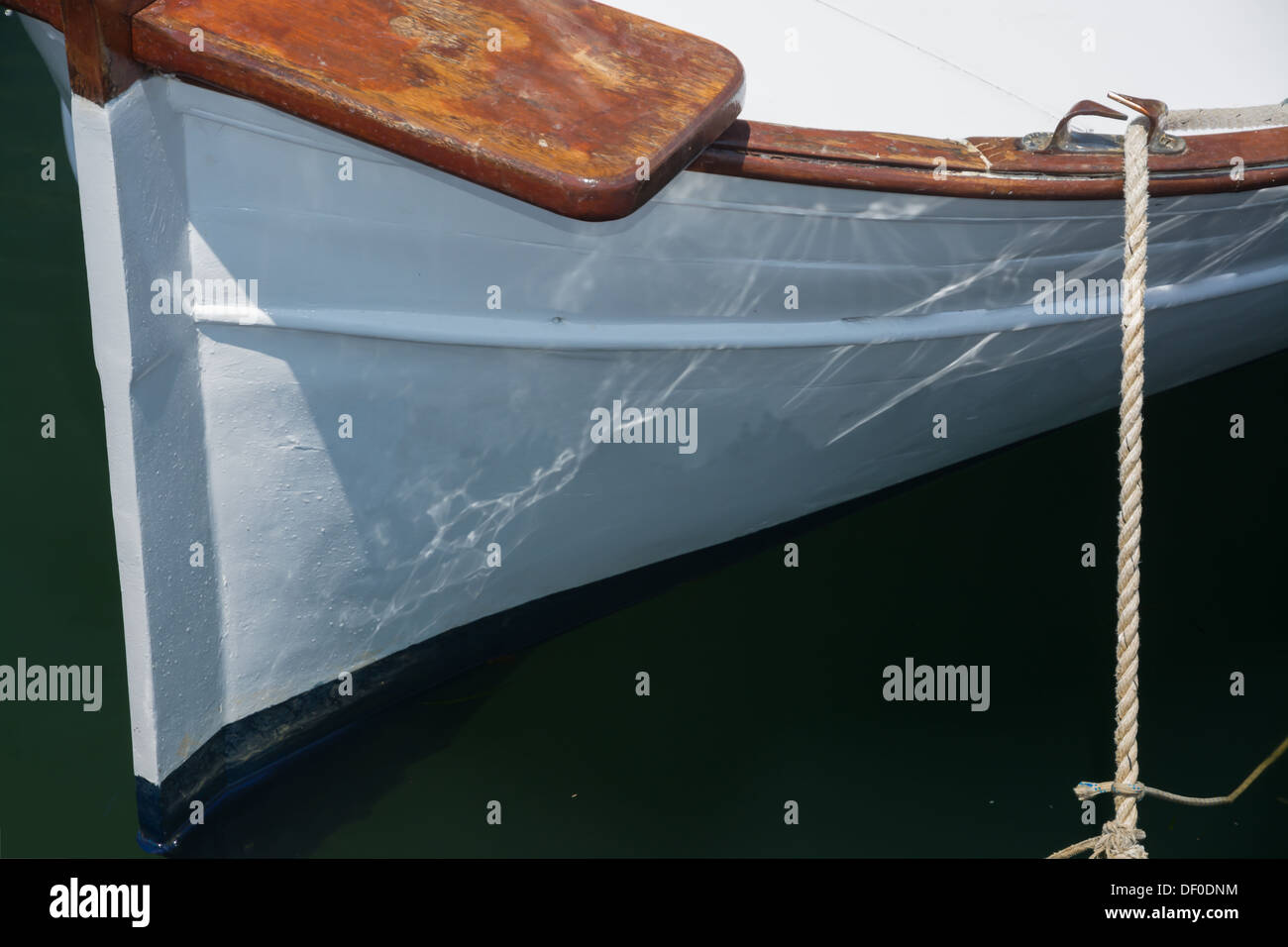 Detail of old white traditional boat with wood details moored. Stock Photo