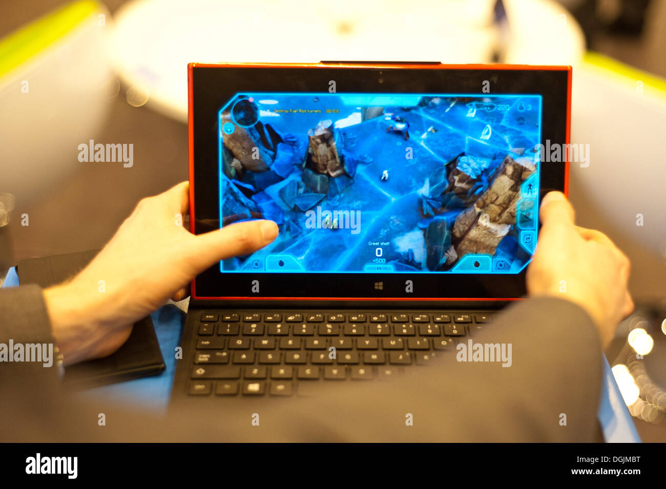 London, UK - 22 October 2013:  a man plays on a Nokia's first Windows tablet, the Lumia 2520, during the Apps World exhibition at Earl's Court 2 in London. Credit:  Piero Cruciatti/Alamy Live News Stock Photo