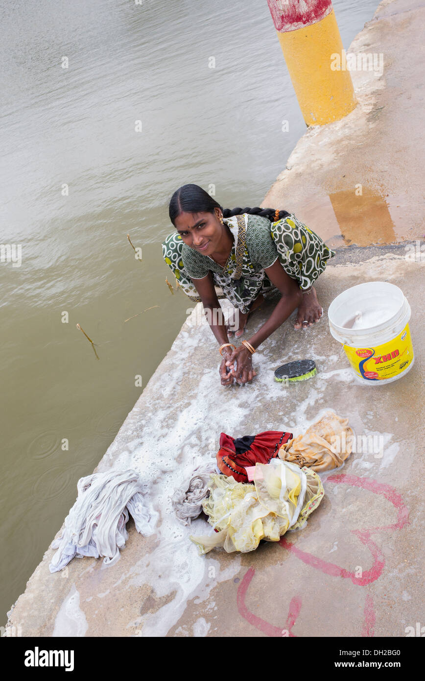 Indian woman washing clothes by hand next to a river. Andhra Pradesh, India Stock Photo