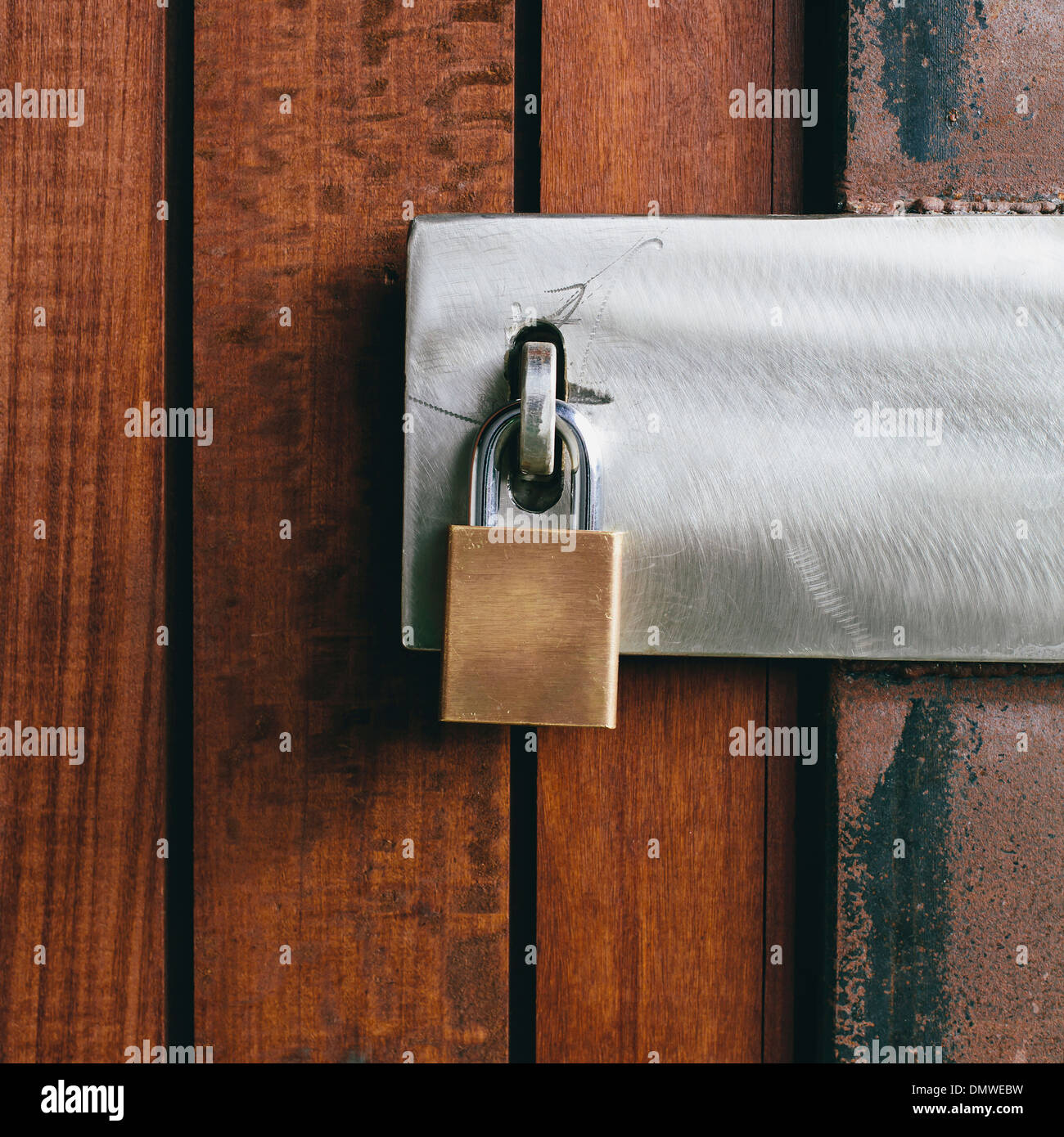 Close up of a wooden doorway with a padlock. Stock Photo