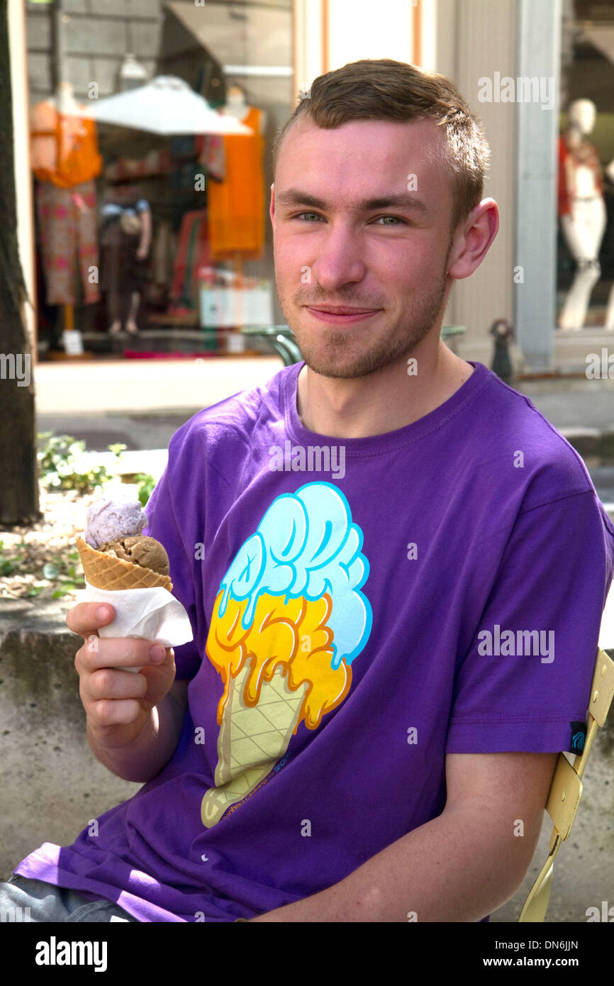 French man eating an ice cream cone wearing a matching t-shirt at Angouleme in southwestern France. Stock Photo