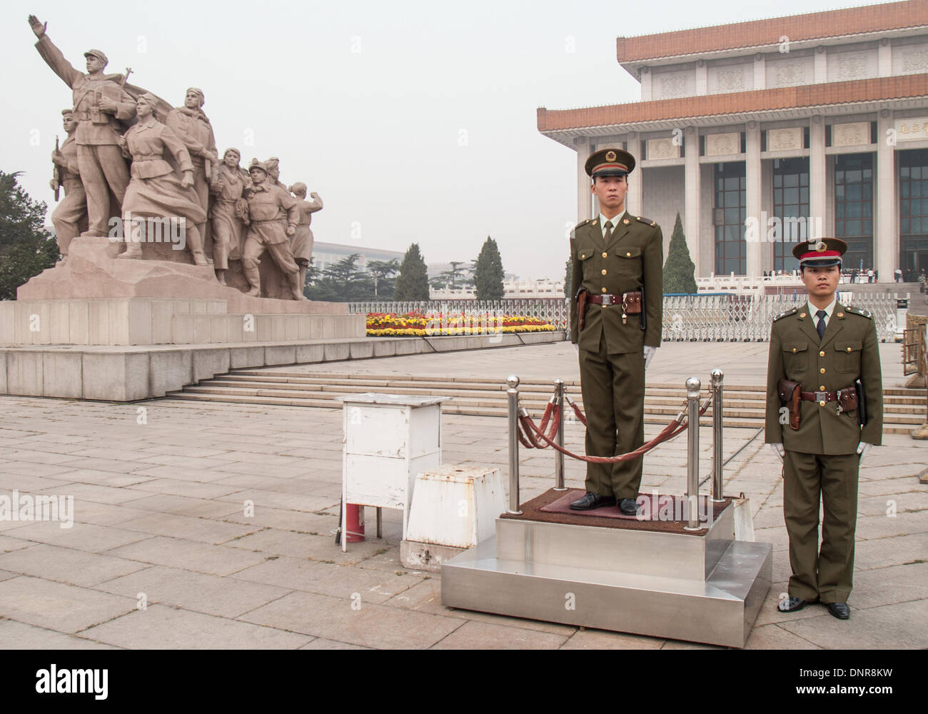 Beijing, China. 16th Oct, 2006. A pair of soldiers of the Chinese People's Liberation Army (PLA) stand guard near the entrance to the Chairman Mao Memorial Hall, commonly known as the Mausoleum of Mao Zedong, his the final resting place. This highly popular attraction is located in Tiananmen Square in Beijing, the capital of the Peoples Republic of China (PRC). At left is a heroic sculpture depicting workers, peasants and soldiers. © Arnold Drapkin/ZUMAPRESS.com/Alamy Live News Stock Photo