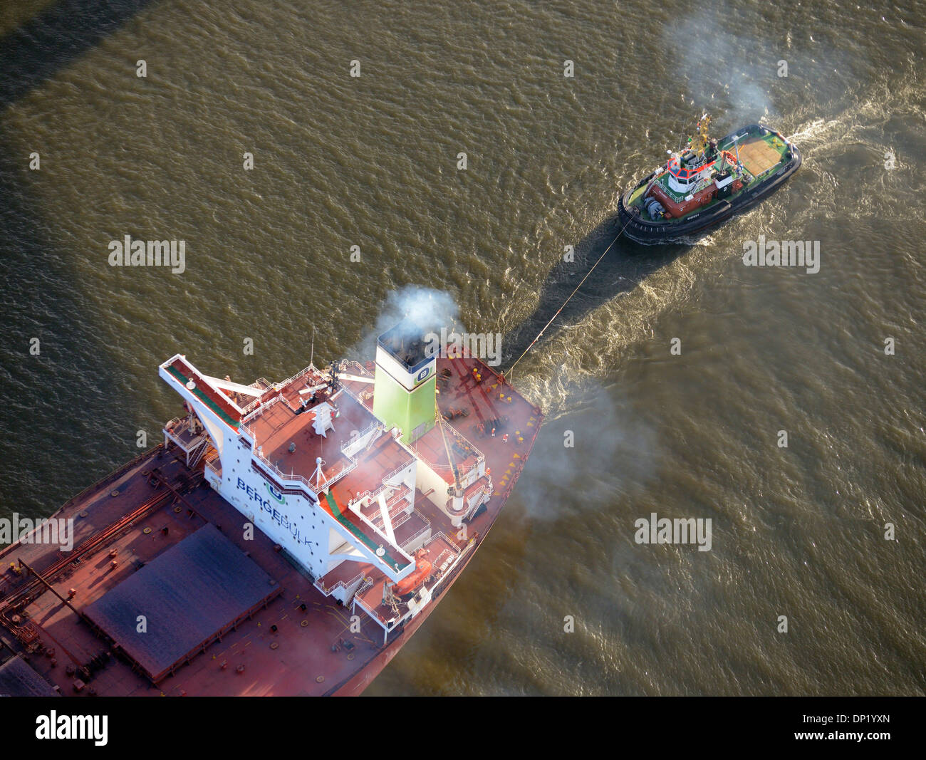 Bugsier 9 tug boat towing the Bergebulk Arctic from the harbor, Hamburg, Germany Stock Photo